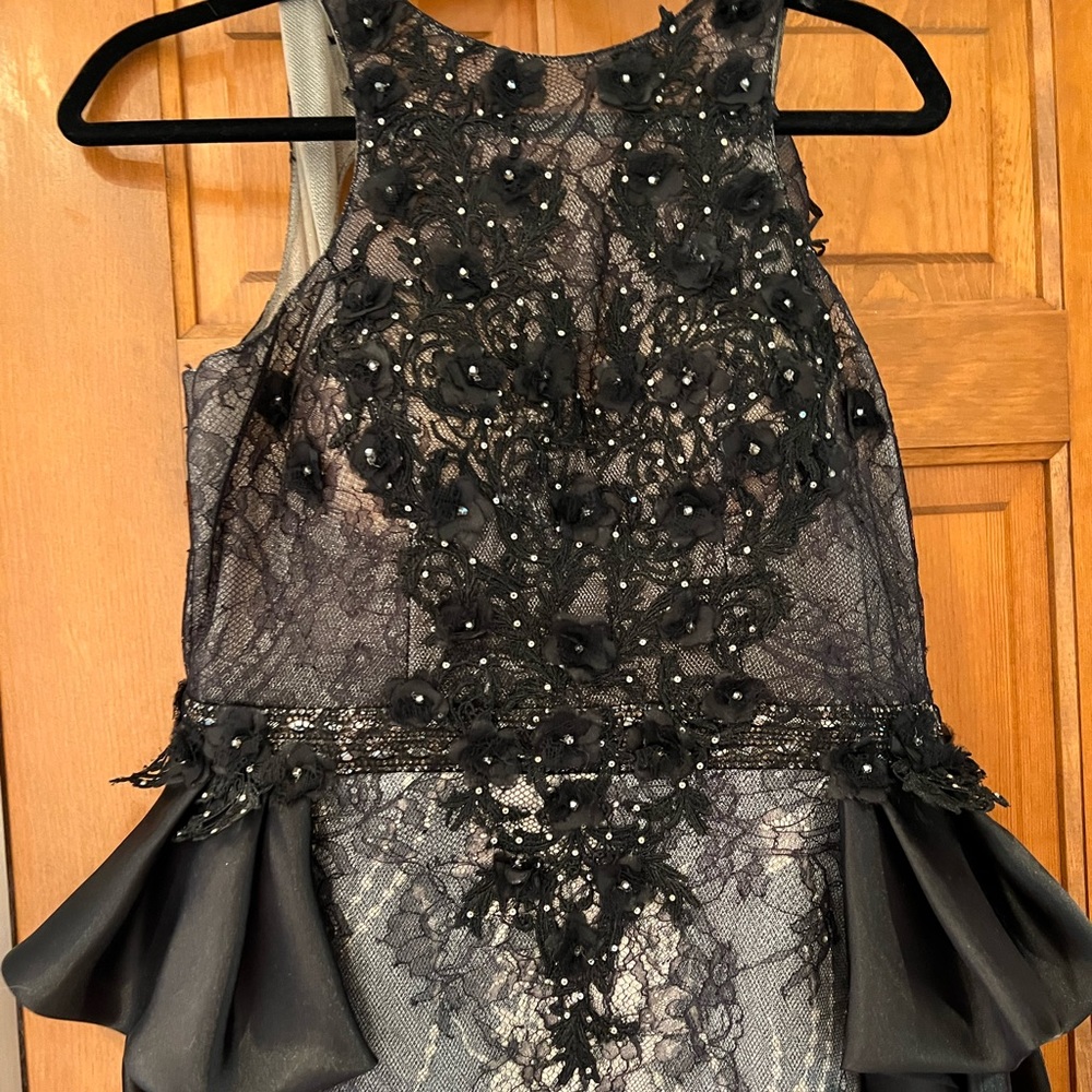 Beautiful Black / nude beaded mini dress with skirt draped in back